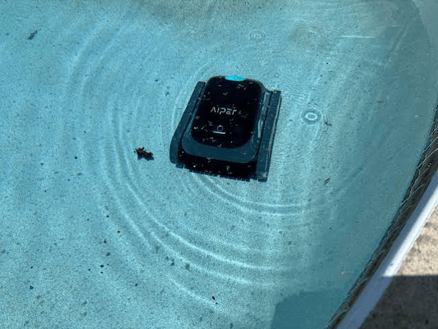Cordless pool vacuum cleaning the floor of a swimming pool