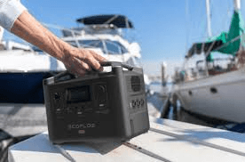 Portable power station on a dock beside house boats and marina slips