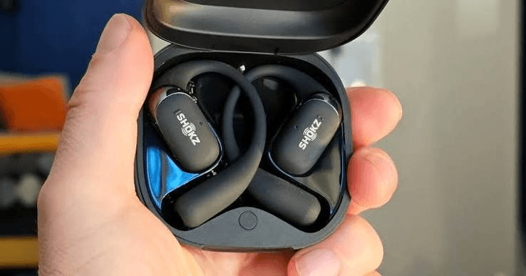 Shokz OpenFit 2 earbuds seated inside the charging case during first setup