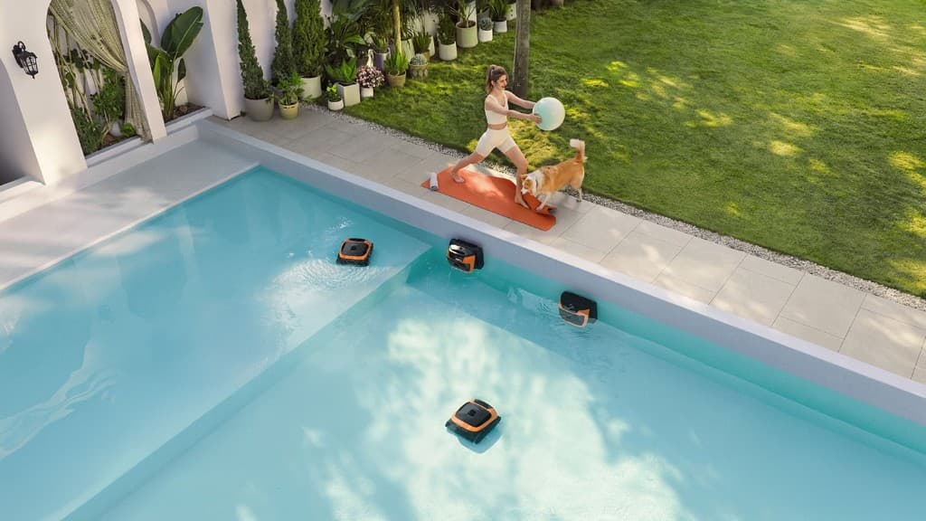 Beatbot Sora 10 robotic pool cleaners cleaning floor, walls, and waterline in a backyard pool